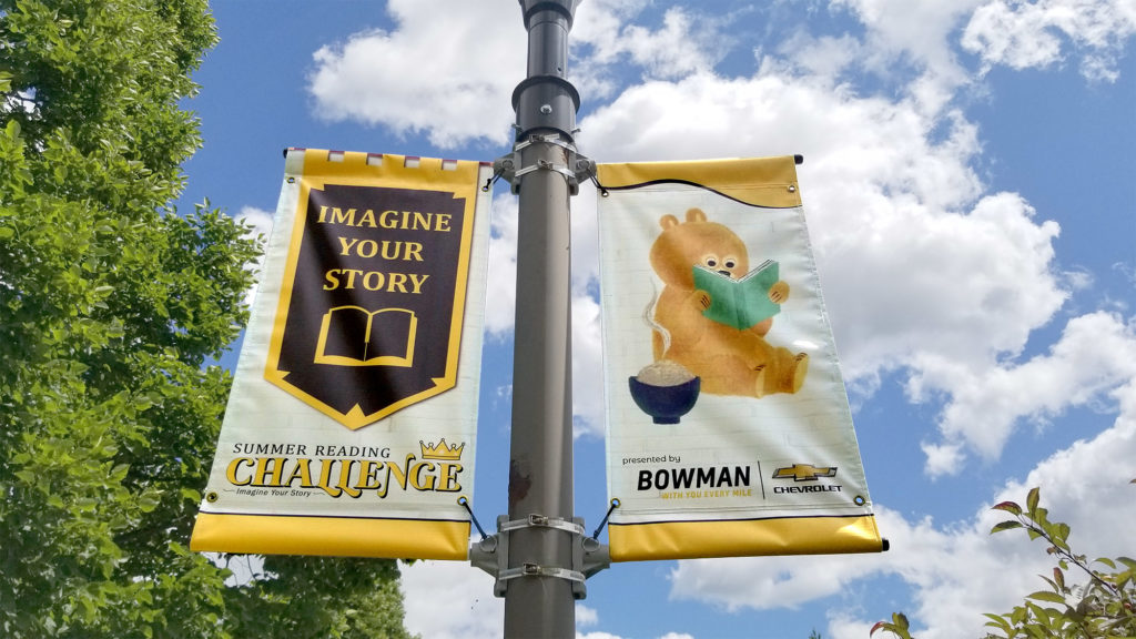 CIDL Summer Reading Challenge 2020 parking lot banners on a pole