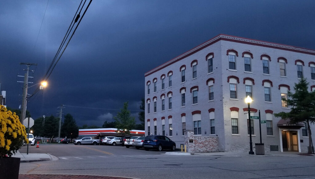 Dark clouds from thunderstorm over town building